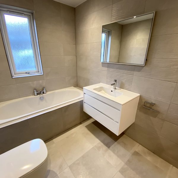 White washbasin, toilet and bath