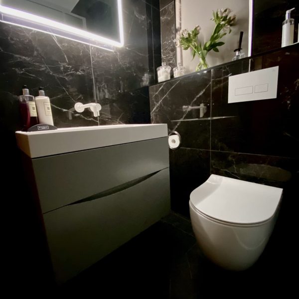 Cloakroom with backlit mirror