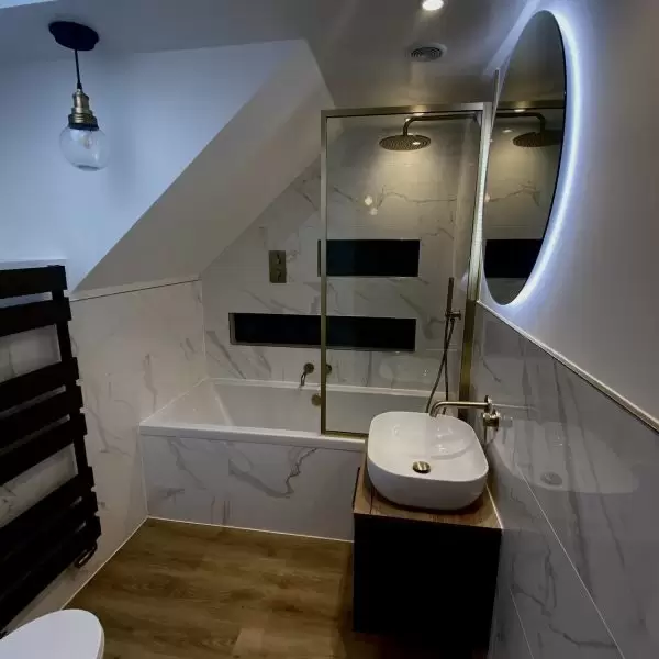 Shower and sink in bathroom with hanging light