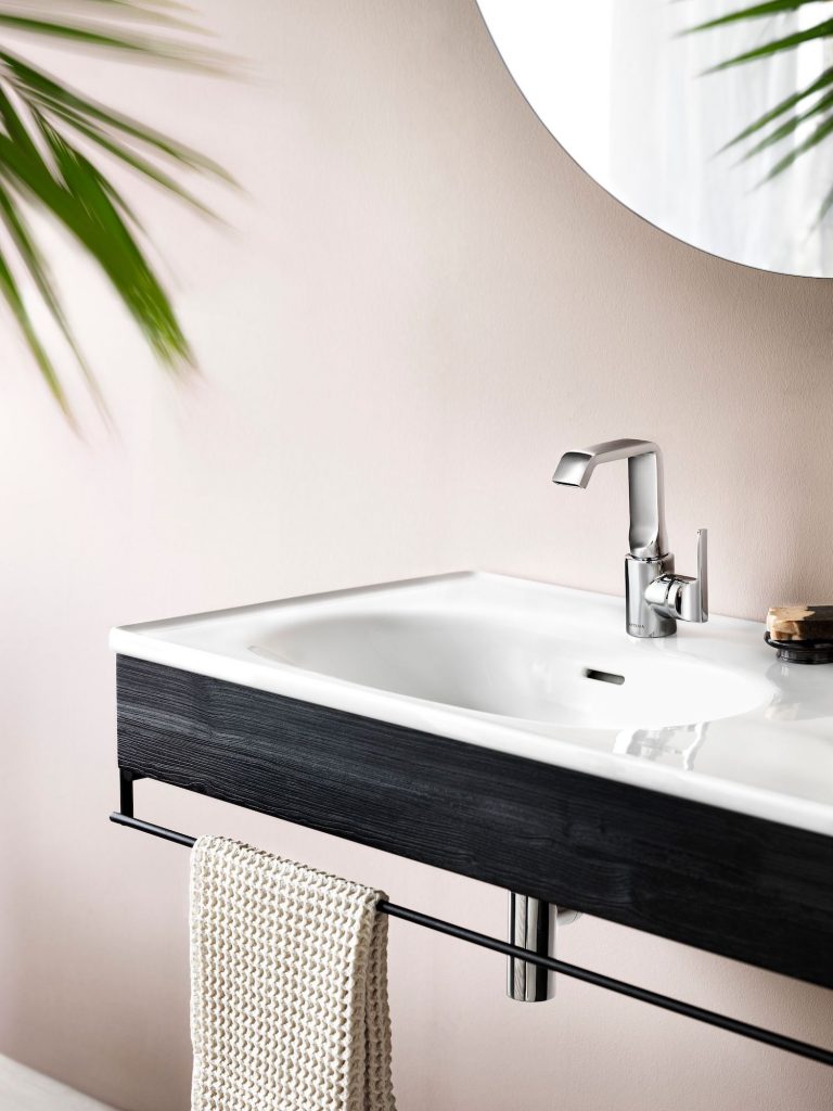 White and black bathroom sink with towel